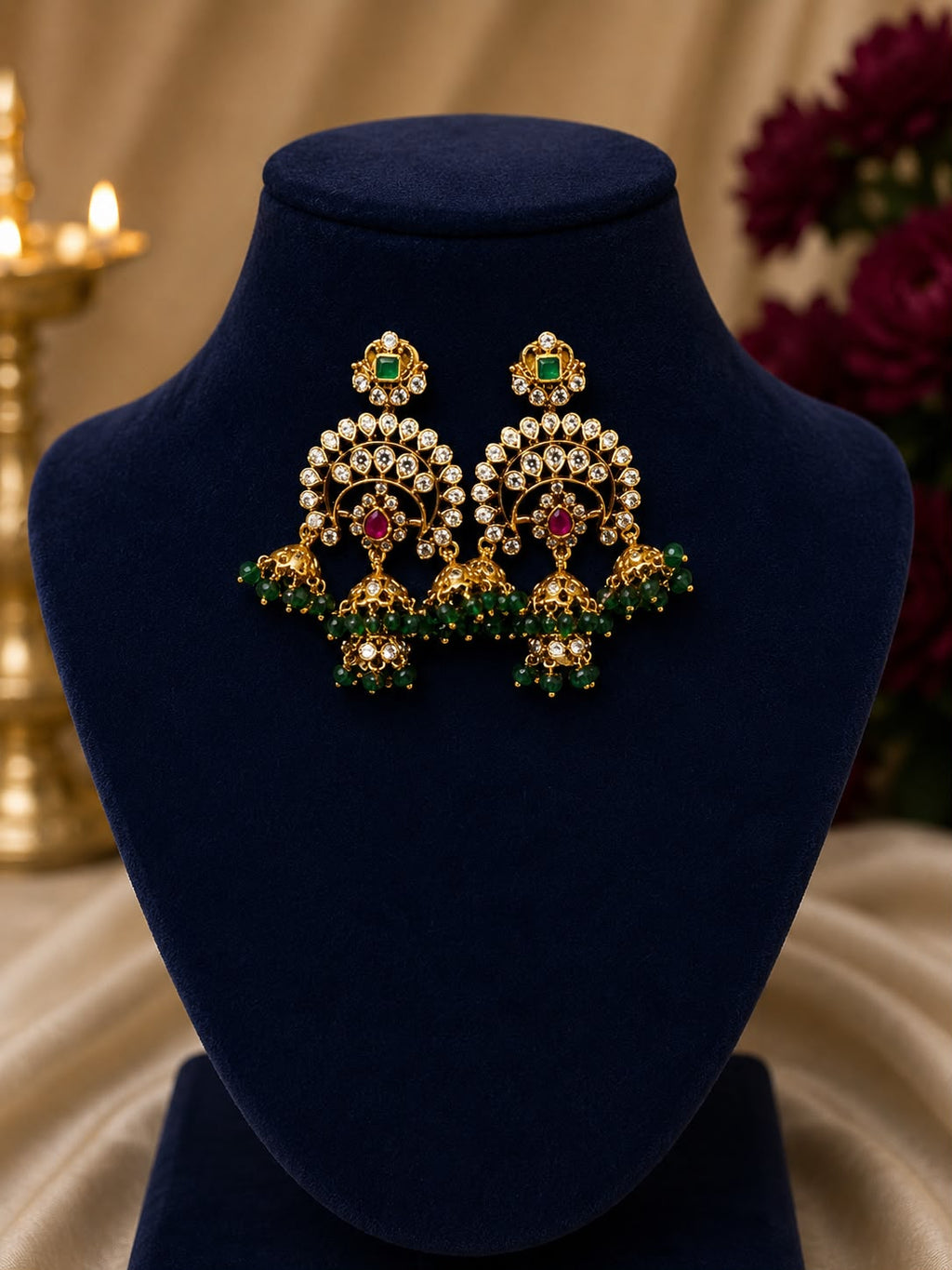 gold-finish chandelier with green beaded earrings